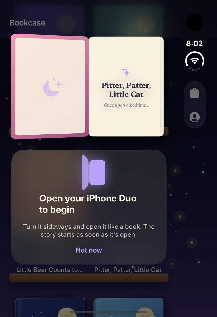A book opening on the shelf with the prompt 'Open your iPhone Duo to begin'